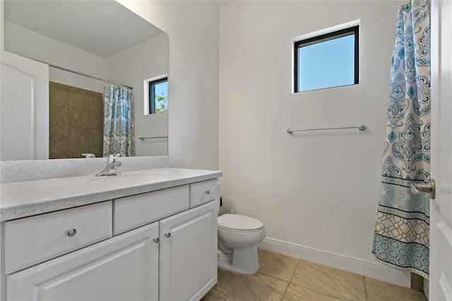 bathroom with tile patterned flooring, vanity, toilet, and plenty of natural light