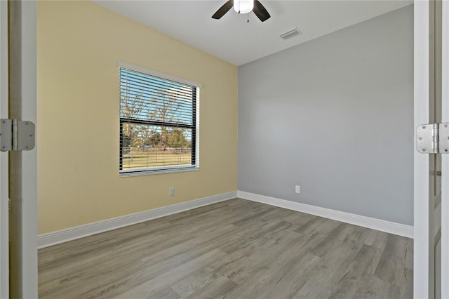 unfurnished room with light hardwood / wood-style flooring and ceiling fan