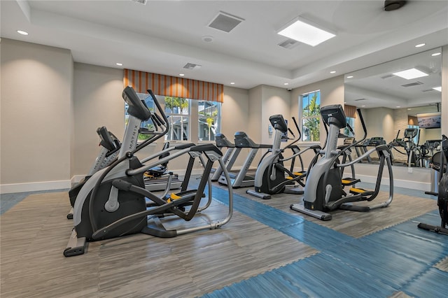 13584 Old Creek Ct, Parrish, FL 34219 - exercise room with recessed lighting, baseboards, plenty of natural light, and a tray ceiling