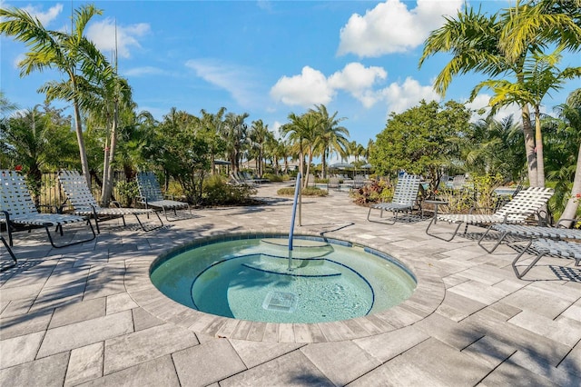 view of pool with a patio area and a hot tub