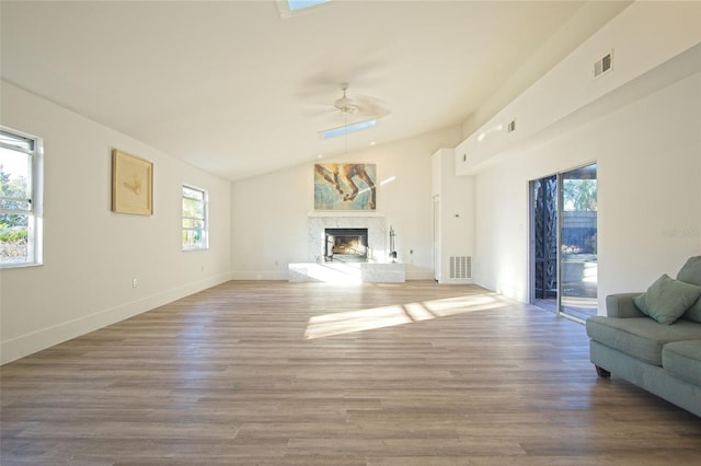 unfurnished living room with ceiling fan, hardwood / wood-style floors, and lofted ceiling