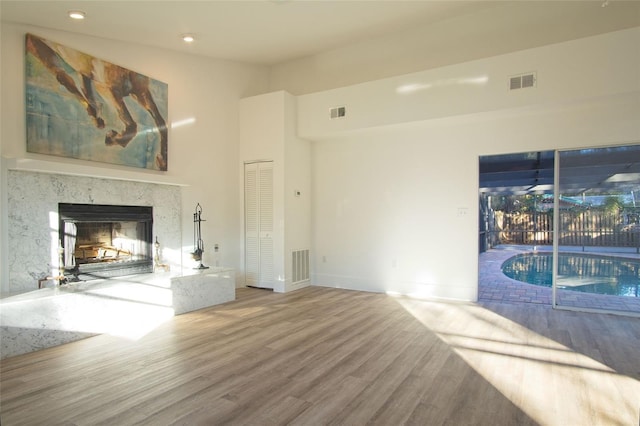 unfurnished living room with hardwood / wood-style floors and a fireplace