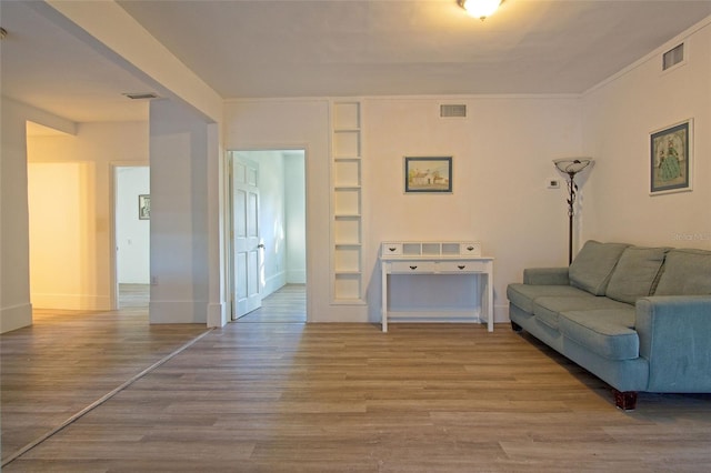 living room featuring ornamental molding and hardwood / wood-style floors