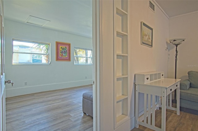 interior space with crown molding and light wood-type flooring