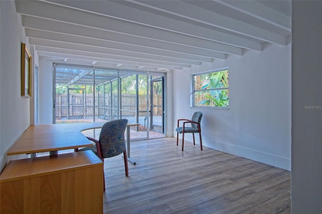 home office featuring hardwood / wood-style flooring, a wall of windows, and beam ceiling