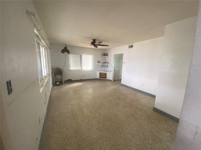 unfurnished living room with ceiling fan