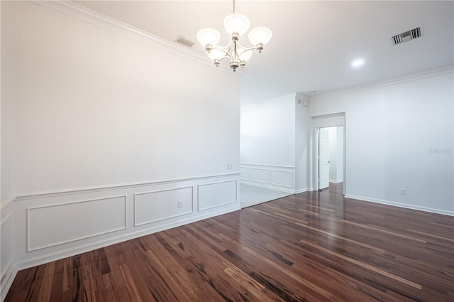 3602 Juneberry Dr, Wesley Chapel, FL 33543 - unfurnished room featuring a chandelier, ornamental molding, dark wood finished floors, a decorative wall, and a wainscoted wall