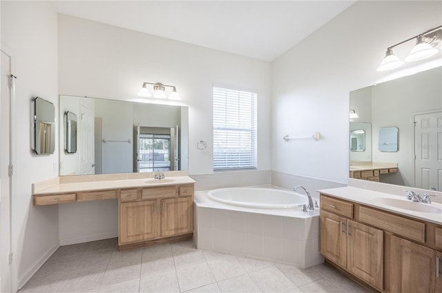 bathroom with tile patterned flooring, vanity, tiled bath, and vaulted ceiling