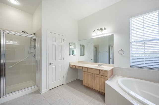 bathroom featuring tile patterned flooring, shower with separate bathtub, and vanity