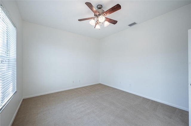 spare room with carpet and ceiling fan