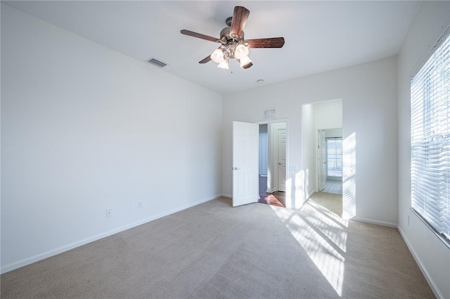 unfurnished bedroom with ceiling fan and light colored carpet