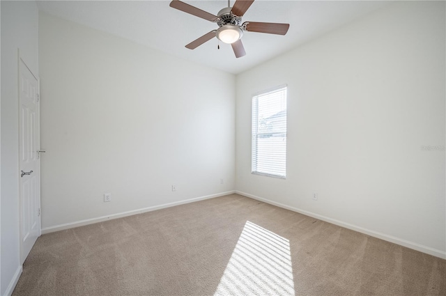 carpeted spare room with ceiling fan