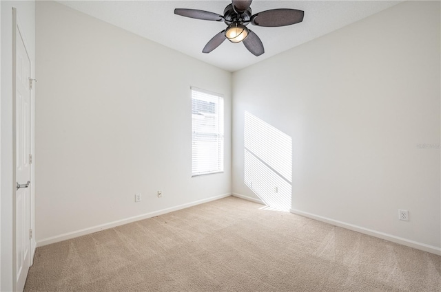 unfurnished room with light colored carpet and ceiling fan