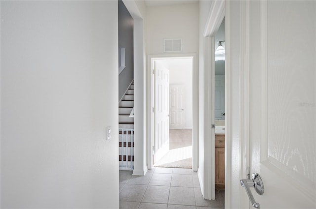 3602 Juneberry Dr, Wesley Chapel, FL 33543 - hall featuring light tile patterned flooring, stairway, and baseboards