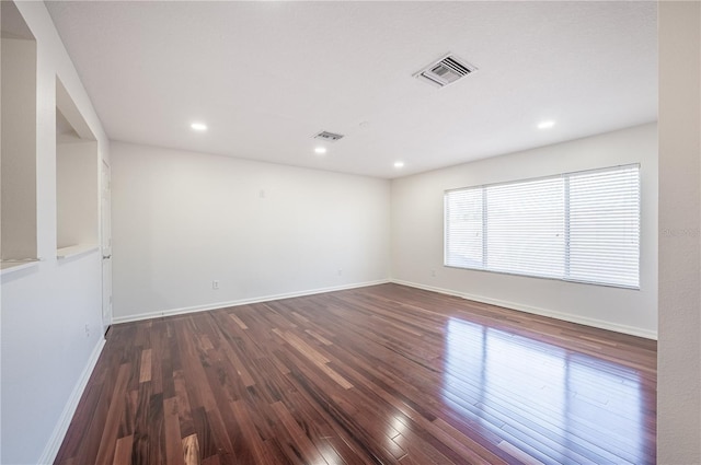 spare room with dark hardwood / wood-style flooring