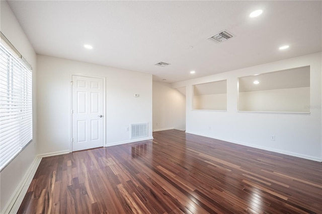 empty room featuring dark hardwood / wood-style flooring