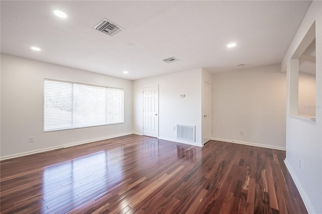 unfurnished room with dark wood-type flooring