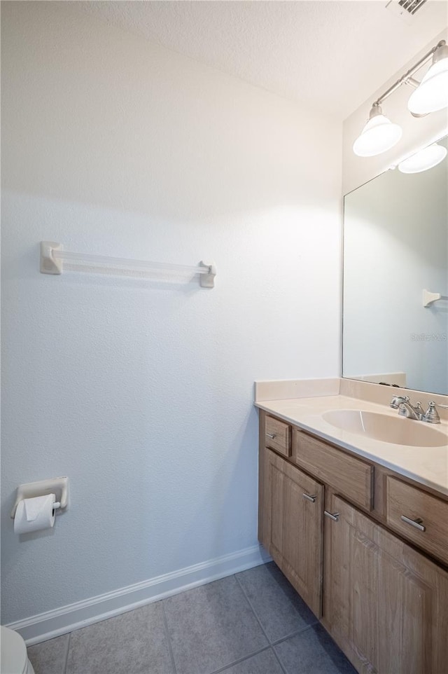 3602 Juneberry Dr, Wesley Chapel, FL 33543 - half bathroom with tile patterned flooring, vanity, toilet, and baseboards