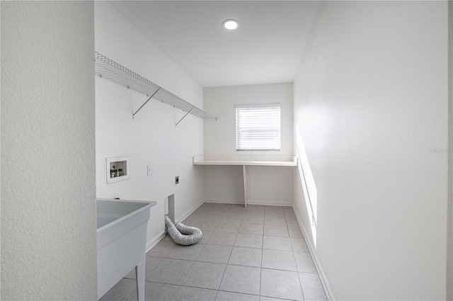 laundry room featuring washer hookup, electric dryer hookup, and light tile patterned floors