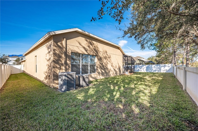 3602 Juneberry Dr, Wesley Chapel, FL 33543 - rear view of property featuring central AC unit and stucco siding