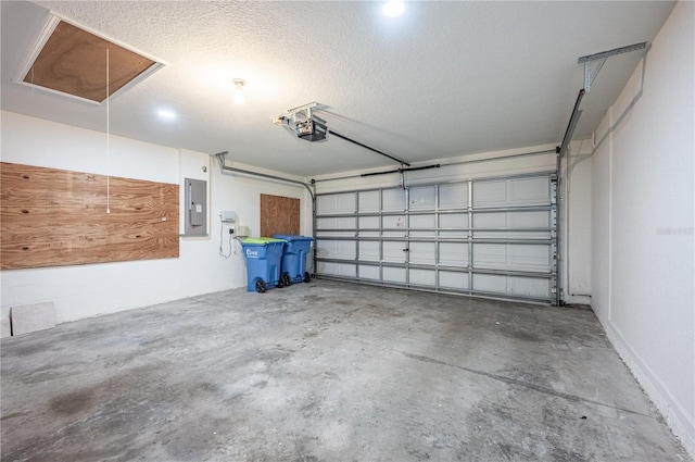 garage with a garage door opener and electric panel