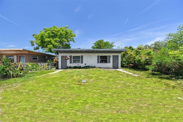 rear view of property with a lawn