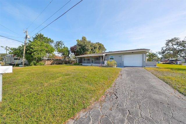 view of front of house with a front yard and a garage