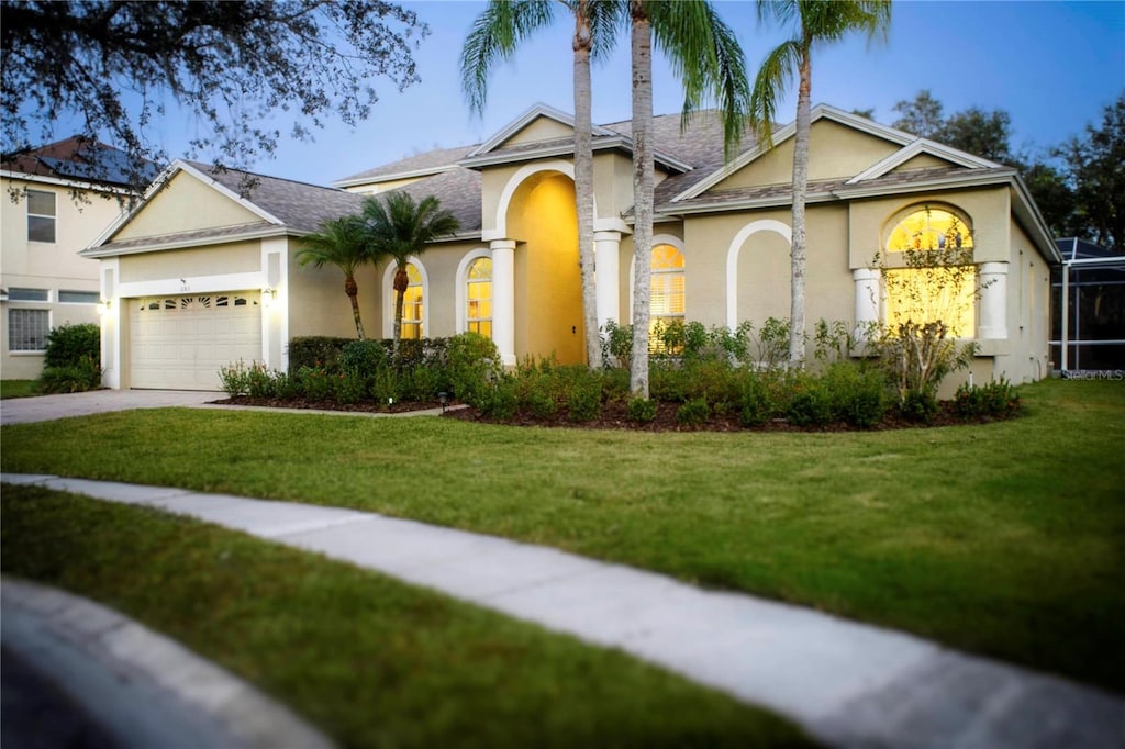 view of front of house with a front yard and a garage