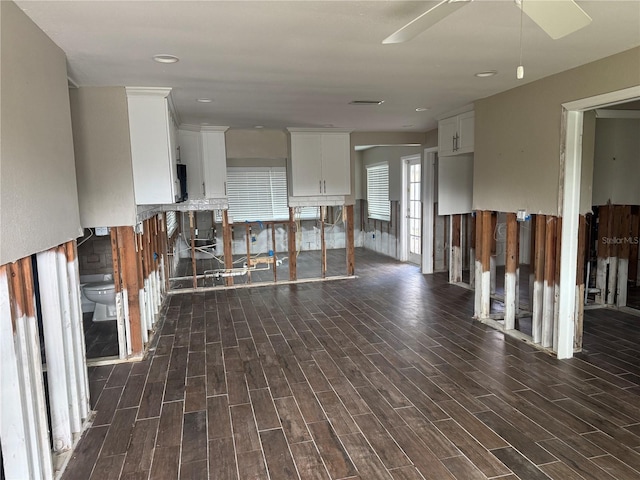 interior space featuring ceiling fan and dark hardwood / wood-style floors