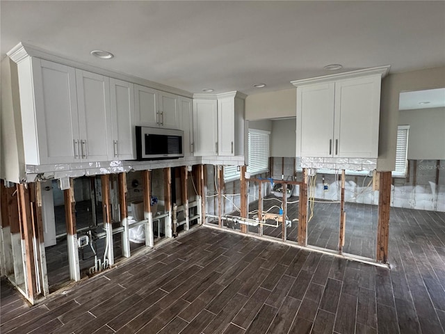 kitchen with white cabinets, a healthy amount of sunlight, dark hardwood / wood-style flooring, and backsplash