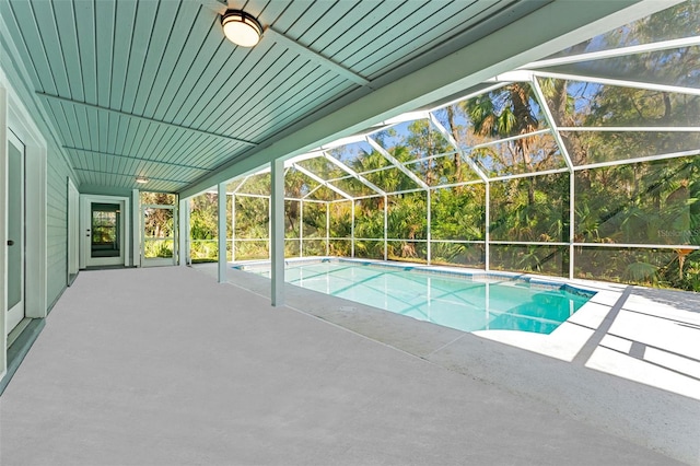 view of pool featuring a patio and glass enclosure