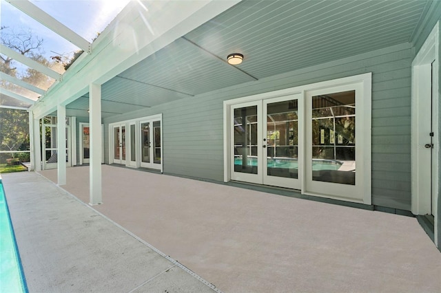 view of patio with french doors and a lanai