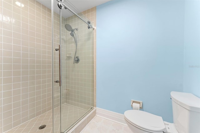 bathroom featuring tile patterned floors, toilet, and an enclosed shower