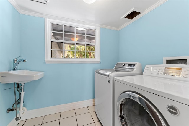 laundry room featuring independent washer and dryer, sink, ornamental molding, and light tile patterned flooring