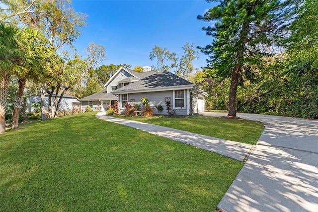 view of front of property with a garage and a front lawn