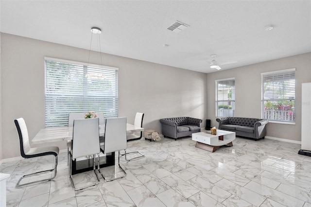 dining room with ceiling fan and a textured ceiling