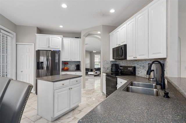 kitchen with tasteful backsplash, sink, black appliances, and white cabinets