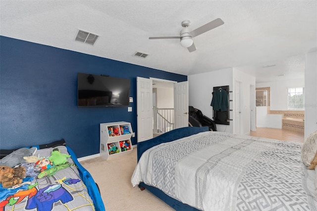 bedroom featuring ceiling fan, carpet, and a textured ceiling