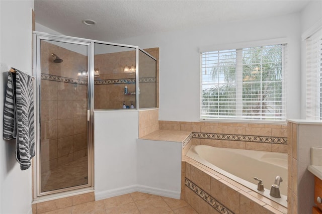 bathroom featuring vanity, tile patterned floors, plus walk in shower, and a textured ceiling