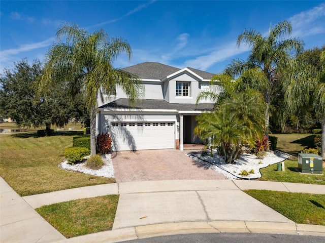 view of front of property with a garage and a front lawn