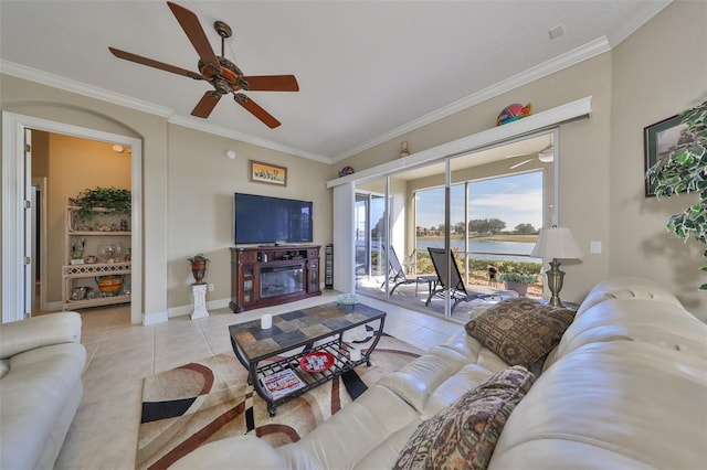 tiled living room with crown molding and ceiling fan