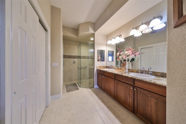 bathroom with tile patterned flooring, vanity, and an enclosed shower