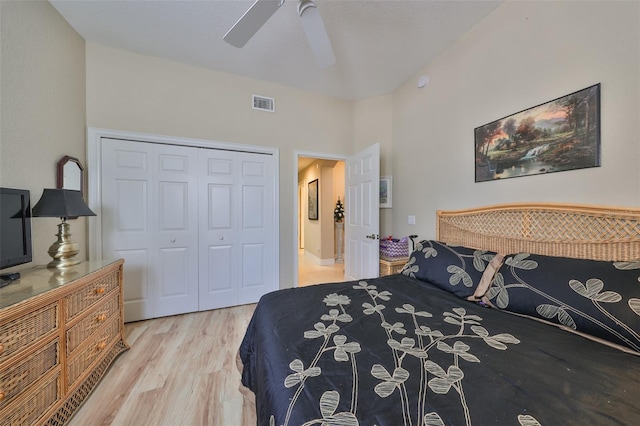 bedroom with ceiling fan, a closet, and light hardwood / wood-style floors