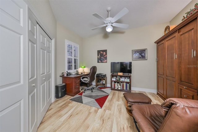 home office with light hardwood / wood-style flooring and ceiling fan