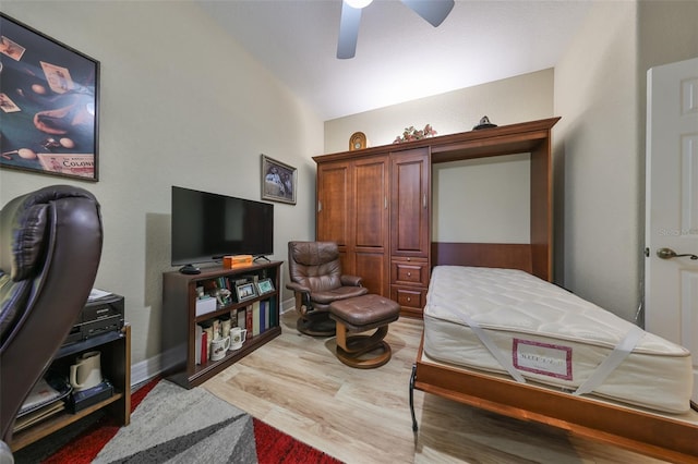 bedroom featuring hardwood / wood-style flooring, ceiling fan, and vaulted ceiling