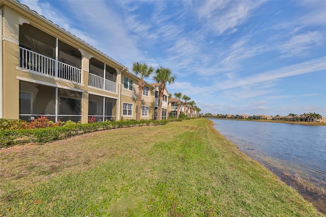 view of community with a water view and a lawn