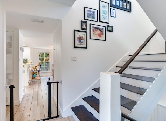 stairs with hardwood / wood-style floors