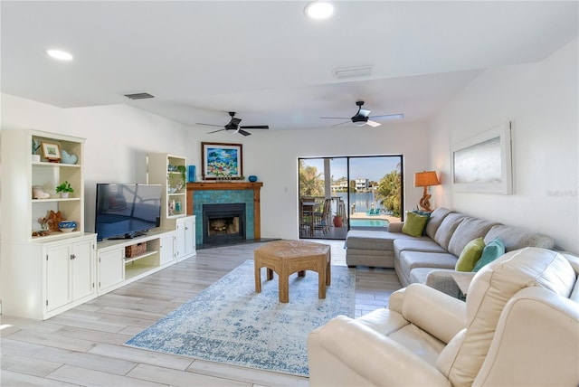 living room featuring light hardwood / wood-style flooring and ceiling fan