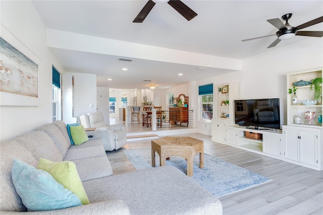 living room featuring ceiling fan and light wood-type flooring