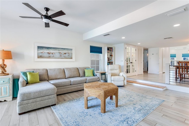 living room featuring light hardwood / wood-style floors and ceiling fan